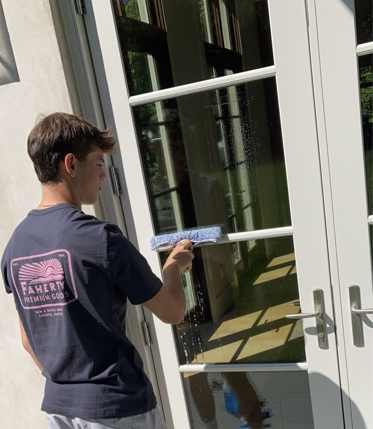 Technician cleaning glass doors