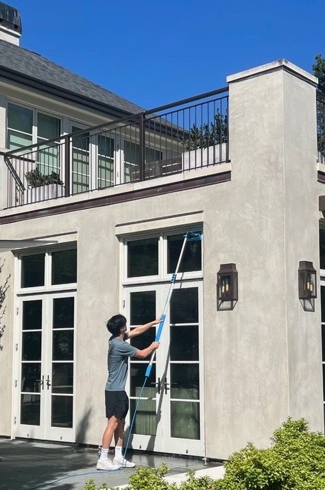 Technician cleaning the exterior of a home